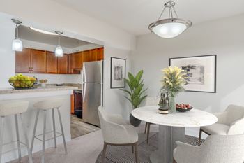 A modern kitchen with a dining table 